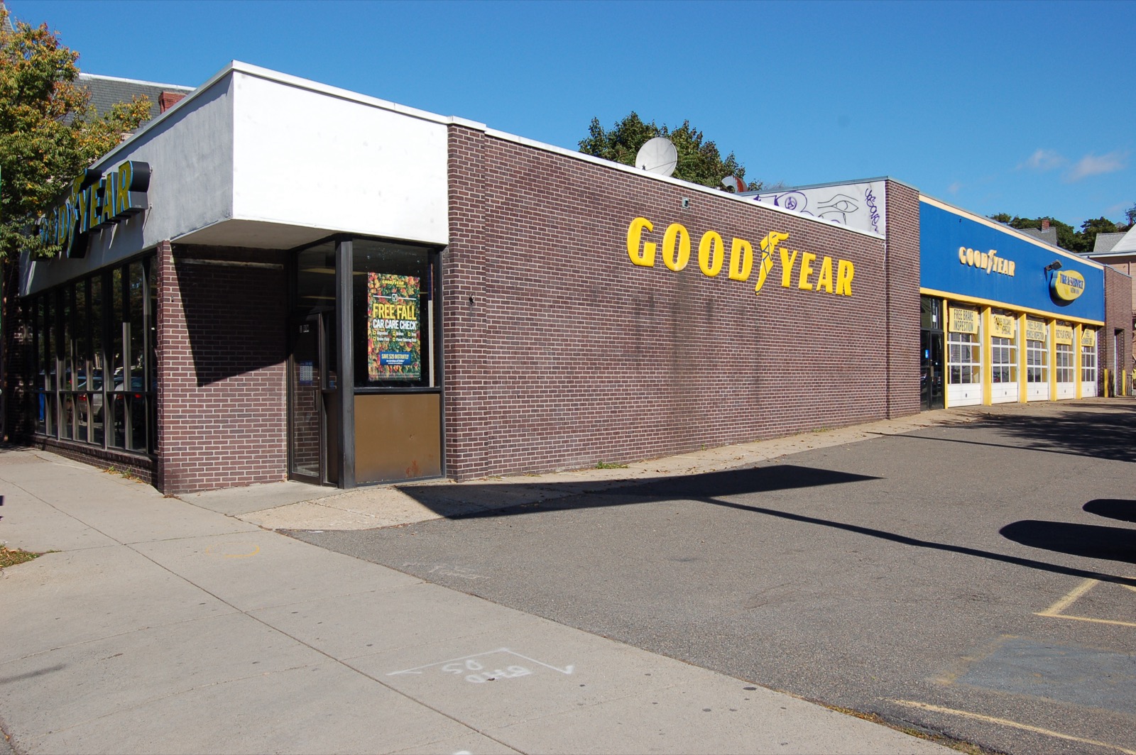 Goodyear service center with the Free Fall Car Care Check poster in the window