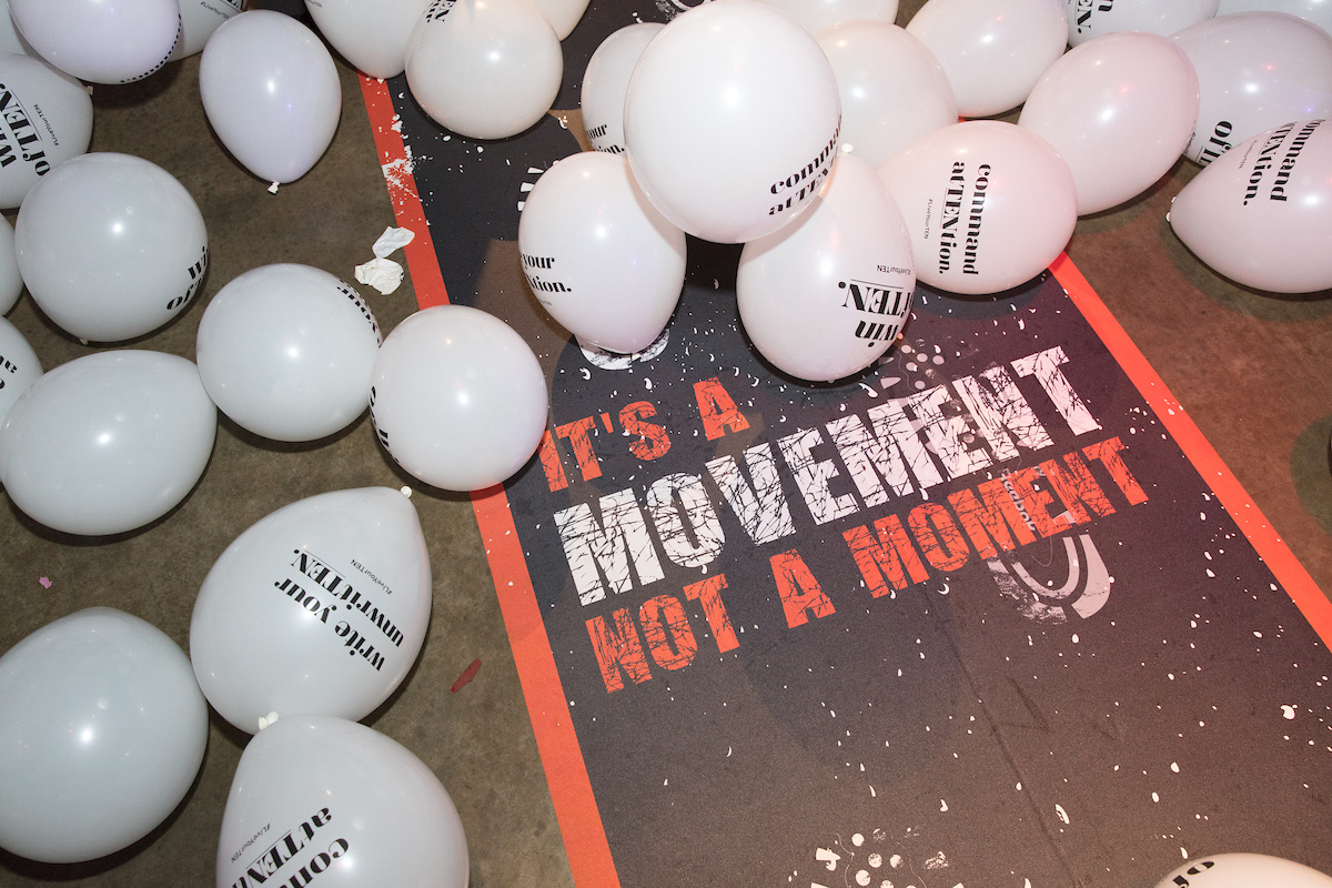 Balloons scattered on the runway beside It's a movement, not a moment