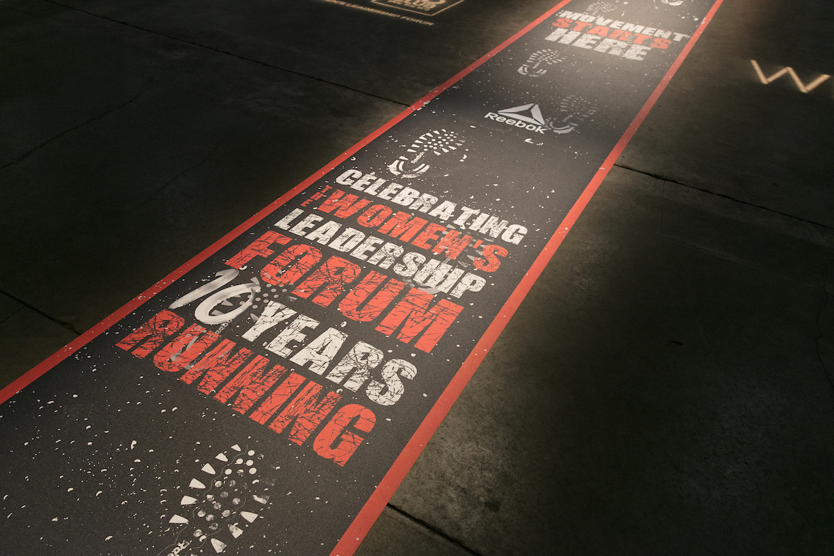 Reebok runway graphic reading Celebrating Women's Leadership Forum, 10 years running